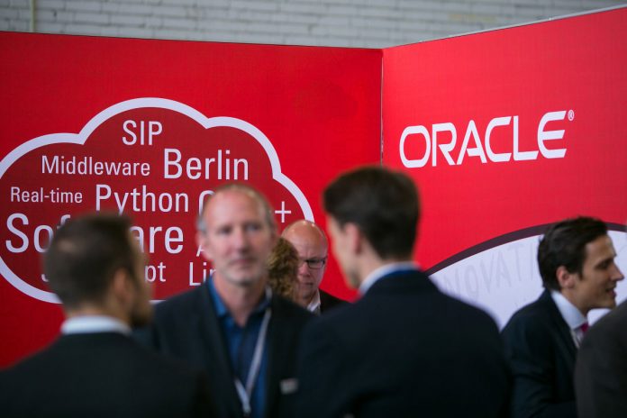 logo of Oracle Corp. sits on the software company's stand at the Connecticum job fair for students, graduates and young professionals at Tempelhof airport in Berlin