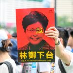 hong kong protester holding sign business news