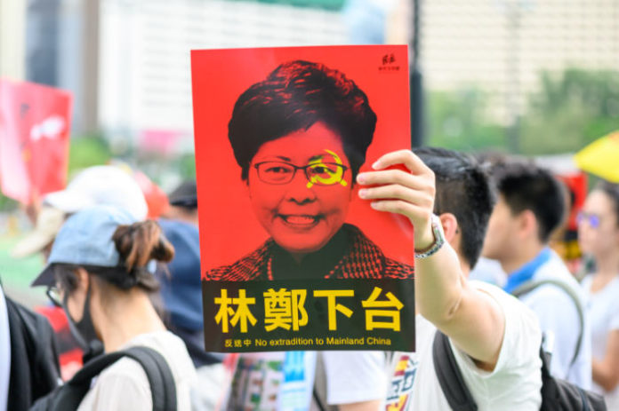 hong kong protester holding sign business news